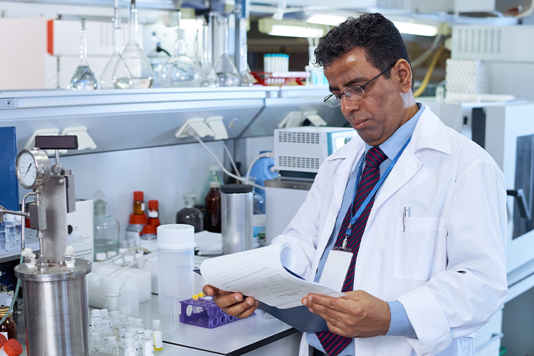 Scientist examining documents in a lab