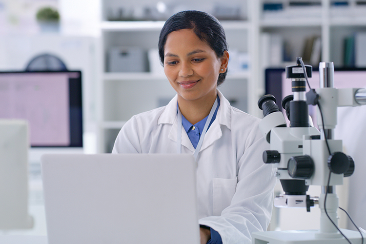 Scientist using her laptop in a lab