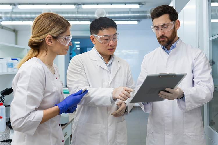 Team of scientists looking at a document