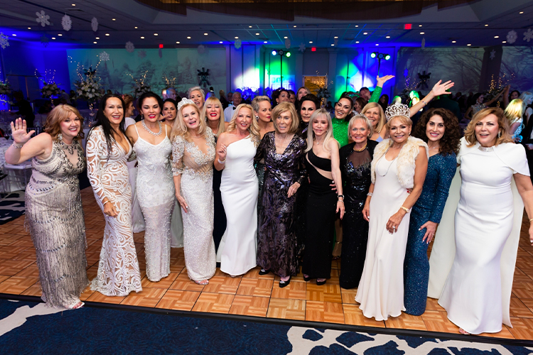 Group of women posing for a photo at an event