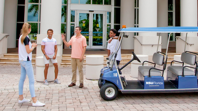 Campus tour group with golf cart