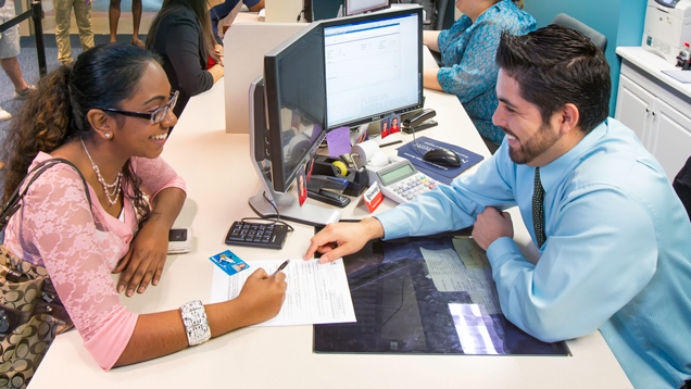 Counselor helping student with admissions documents