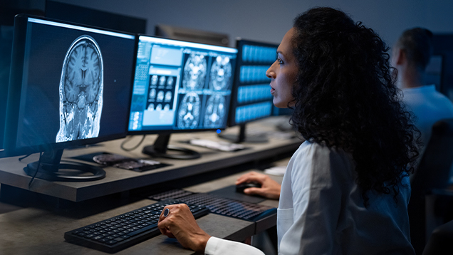 Doctor looking at MRI scans on her computer