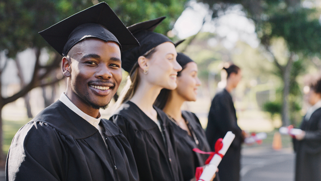 Group of graduates with cap and gown mix majors