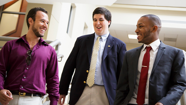 Group of NSU business students walking and smiling