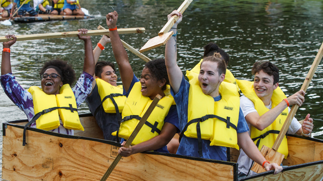 Homecoming lake race students event on wood boat