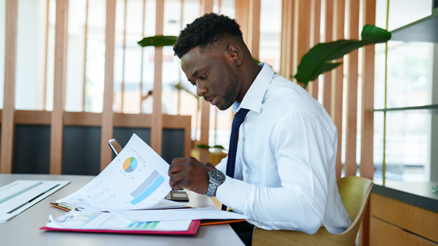 Man managing financing reading at papers