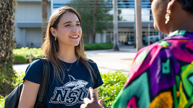 NSU student speaking with a woman on campus