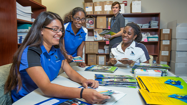 NSU students preparing folders for an event