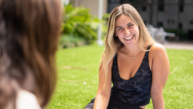 Smiling student relax on campus outdoors