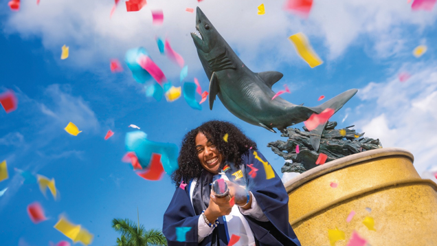 Student after graduation throwing confetti