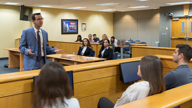 Trial lawyer speaking to the jury in a courtroom