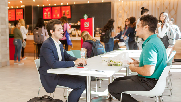 Two students chatting at campus food court