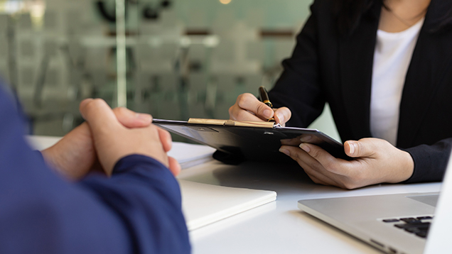 Woman interviews student in office close up