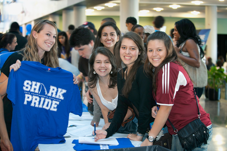 At event student holding shark pride shirt