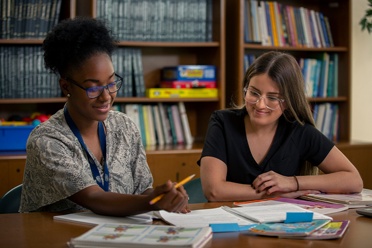 NSU students studying together and taking notes