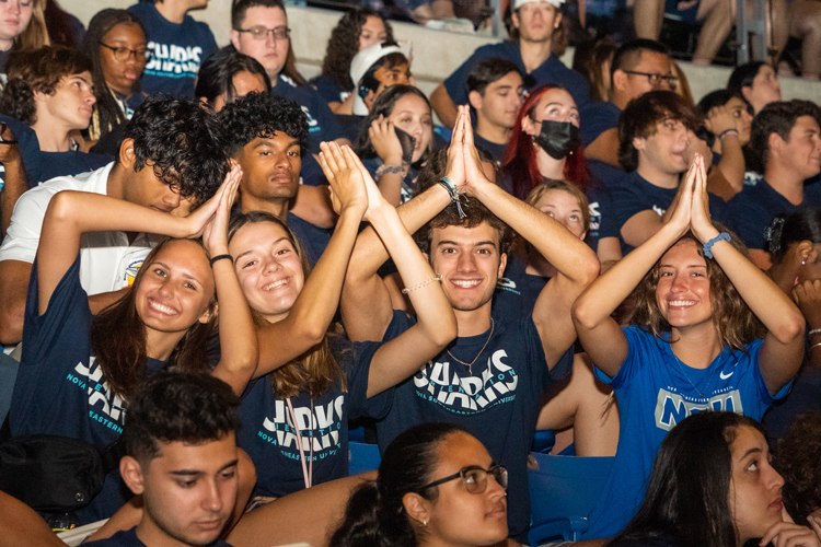 Undergrad students at convocation fins up.